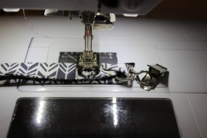 Stitched across the two pieces about 1 inch from the ring.