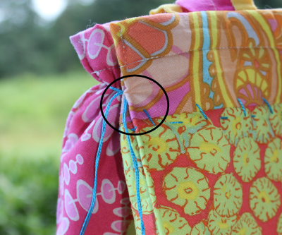 USE YOUR TOP STITCH FOOT (Bernina No. 5) to stich each side and around the bottom. It give stability to the tote. Divide the length of the bottom side seam, then measure over half that length from the middle seam. Press down the sides. Stitch, setting the needle over about 5 notches. It creates a small seam down the side.